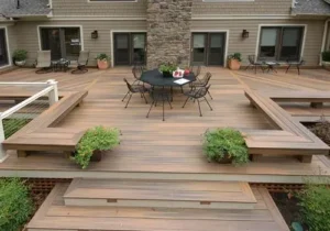 Large multi-level low wood deck with broad steps, planters, and a dining area