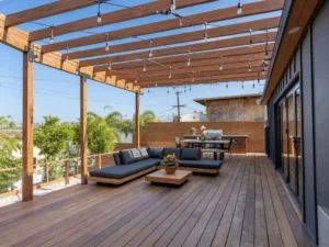 Large wood terrace with a pergola, string lights, and modern outdoor seating
