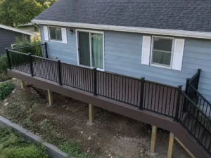 Long raised brown deck supported by posts with black metal railings